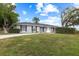 Traditional home with a manicured lawn, dark shutters, and freshly painted exterior at 12 Lake Link Dr, Winter Haven, FL 33884