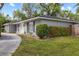 Exterior view of a well-manicured front yard with a charming home at 12 Lake Link Dr, Winter Haven, FL 33884