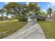 Landscaped front yard with a long driveway leading up to a beautifully maintained home at 12 Lake Link Dr, Winter Haven, FL 33884