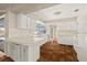 Bright kitchen featuring white cabinets, stainless steel appliances, and terracotta tile floors at 12 Lake Link Dr, Winter Haven, FL 33884