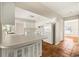 Bright kitchen featuring white cabinets, stainless steel appliances, and terracotta tile floors at 12 Lake Link Dr, Winter Haven, FL 33884