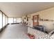 Enclosed back porch with a view of the outdoors, with an air conditioning unit in front of an exterior door at 12172 Se 96Th Ter, Belleview, FL 34420