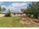 Landscaped backyard featuring a green lawn, mature trees, and defined planting beds and borders at 12172 Se 96Th Ter, Belleview, FL 34420