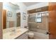 Well-lit bathroom featuring a vanity with a cultured marble countertop, tiled shower, and glass door at 12172 Se 96Th Ter, Belleview, FL 34420