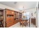 Traditional dining room featuring a large wooden cabinet and a table set for four near a bright window at 12172 Se 96Th Ter, Belleview, FL 34420