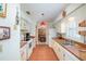 Functional kitchen features white cabinets, tile floors, and ample counter space, perfect for everyday cooking at 12172 Se 96Th Ter, Belleview, FL 34420