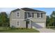 Two story home with gray siding and black shutters with an attached two car garage at 2918 Pennachio Dr, Lake Wales, FL 33859