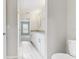 Bright bathroom featuring a granite vanity, a modern mirror, and a toilet at 3230 Baird Ave, Lakeland, FL 33805