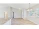 Bright dining area featuring wood floors, a modern chandelier, and a large window at 3230 Baird Ave, Lakeland, FL 33805