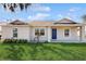 Charming single-story home with a well-manicured lawn and inviting blue front door at 3230 Baird Ave, Lakeland, FL 33805