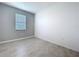 Gray bedroom with tile flooring and natural light from the window at 6244 Great Bear Dr, Lakeland, FL 33805