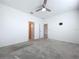 Spacious bedroom featuring a ceiling fan, neutral color palette, and open doorway at 6244 Great Bear Dr, Lakeland, FL 33805