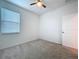 A bedroom with carpet, a window, and a ceiling fan at 6244 Great Bear Dr, Lakeland, FL 33805