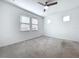 Bright bedroom featuring carpet flooring, a ceiling fan, and natural light from multiple windows at 6244 Great Bear Dr, Lakeland, FL 33805