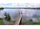 Long community dock extending into a tranquil lake, perfect for enjoying scenic views and nature at 6244 Great Bear Dr, Lakeland, FL 33805