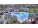 Community pool featuring palm trees, lounge chairs, and a clubhouse, perfect for relaxation and recreation at 6244 Great Bear Dr, Lakeland, FL 33805