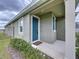 Welcoming front porch with a blue door and matching shutter, providing a charming entrance to this cozy home at 6244 Great Bear Dr, Lakeland, FL 33805