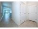 Hallway with tile flooring leading to a bright living area with a balcony at 6244 Great Bear Dr, Lakeland, FL 33805