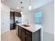 Well-lit kitchen featuring a center island with stainless steel sink and modern pendant lights at 6244 Great Bear Dr, Lakeland, FL 33805