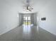 Bright living room featuring a ceiling fan, tile floors, neutral paint, and an abundance of natural light at 6244 Great Bear Dr, Lakeland, FL 33805