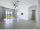 Bright living room featuring a ceiling fan, tile floors, neutral paint, and an abundance of natural light at 6244 Great Bear Dr, Lakeland, FL 33805