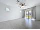 Bright living room featuring a ceiling fan, tile floors, neutral paint, and an abundance of natural light at 6244 Great Bear Dr, Lakeland, FL 33805