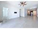 Bright living room featuring a ceiling fan, tile floors, neutral paint, and an abundance of natural light at 6244 Great Bear Dr, Lakeland, FL 33805