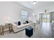 Bright living room featuring tile floors and neutral decor, with a view into the dining area at 6244 Great Bear Dr, Lakeland, FL 33805