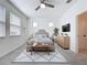 Comfortable main bedroom featuring a ceiling fan, carpet, neutral paint, and an abundance of natural light at 6244 Great Bear Dr, Lakeland, FL 33805