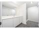 Bright bathroom featuring a spacious vanity with modern countertops and ample storage, complemented by stylish gray wood-look flooring at 3739 Bergamot St, Lake Alfred, FL 33850