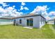 Landscaped backyard offers a lush lawn and a patio, perfect for outdoor activities and relaxation at 3804 Corsican Pl, Lake Alfred, FL 33850