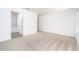 Bright bedroom features plush carpeting, neutral paint, ensuite bathroom, and walk-in closet at 3804 Corsican Pl, Lake Alfred, FL 33850