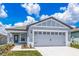 Charming single-Gathering home featuring a two-car garage, lovely landscaping, and a covered front porch at 3804 Corsican Pl, Lake Alfred, FL 33850