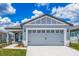 Charming single-Gathering home featuring a two-car garage, lovely landscaping, and a covered front porch at 3804 Corsican Pl, Lake Alfred, FL 33850