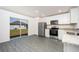 Modern kitchen with white cabinets, stainless steel appliances, granite countertops, and sliding glass door to the backyard at 3804 Corsican Pl, Lake Alfred, FL 33850