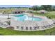 Stunning community pool with lounge chairs and a covered seating area at 4727 Bold Peacock Bnd, Bartow, FL 33830