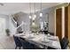 Bright dining room with modern lighting, dining set, staircase and light tile flooring at 627 Jasmine Ln, Davenport, FL 33897