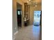 Bright entryway with tile flooring, modern light fixture, decorative console table, and views into adjacent rooms at 627 Jasmine Ln, Davenport, FL 33897