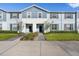 Charming townhome with a blue exterior, well-manicured lawn, and inviting walkway at 627 Jasmine Ln, Davenport, FL 33897