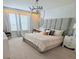 Bright bedroom featuring a large bed, contemporary lighting, and an ensuite desk area at 627 Jasmine Ln, Davenport, FL 33897