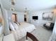 Bright main bedroom features neutral tones, soft carpet, decorative headboard, and a contemporary chandelier at 627 Jasmine Ln, Davenport, FL 33897