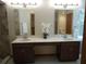 Modern bathroom with double vanity sinks, a tiled walk-in shower, and updated fixtures at 1547 Belfast Ct, Apopka, FL 32712