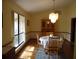 Cozy dining room featuring wood floors, large window and modern decorative lighting at 1547 Belfast Ct, Apopka, FL 32712