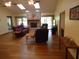 Well-lit living room featuring hardwood floors, brick fireplace and large windows at 1547 Belfast Ct, Apopka, FL 32712