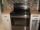 Kitchen with stainless steel stove and decorative tile backsplash at 2502 Vine St, Orlando, FL 32806