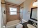 Bathroom featuring a shower-tub combo with tiled walls, a modern vanity and neutral decor at 6187 Brookhill Cir, Orlando, FL 32810