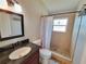 Bathroom featuring a shower with tiled walls and floor, a modern vanity and neutral decor at 6187 Brookhill Cir, Orlando, FL 32810