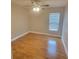 Bedroom features wood floors, neutral paint, a ceiling fan and a window at 6187 Brookhill Cir, Orlando, FL 32810