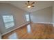 Bedroom featuring hardwood floors, a ceiling fan and windows for natural light at 6187 Brookhill Cir, Orlando, FL 32810