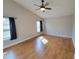 Bedroom featuring hardwood floors, a ceiling fan and windows for natural light at 6187 Brookhill Cir, Orlando, FL 32810